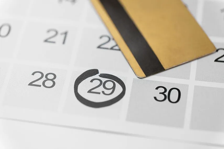 shopping, sale and marketing concept - close up of black friday date on calendar and credit card
                            