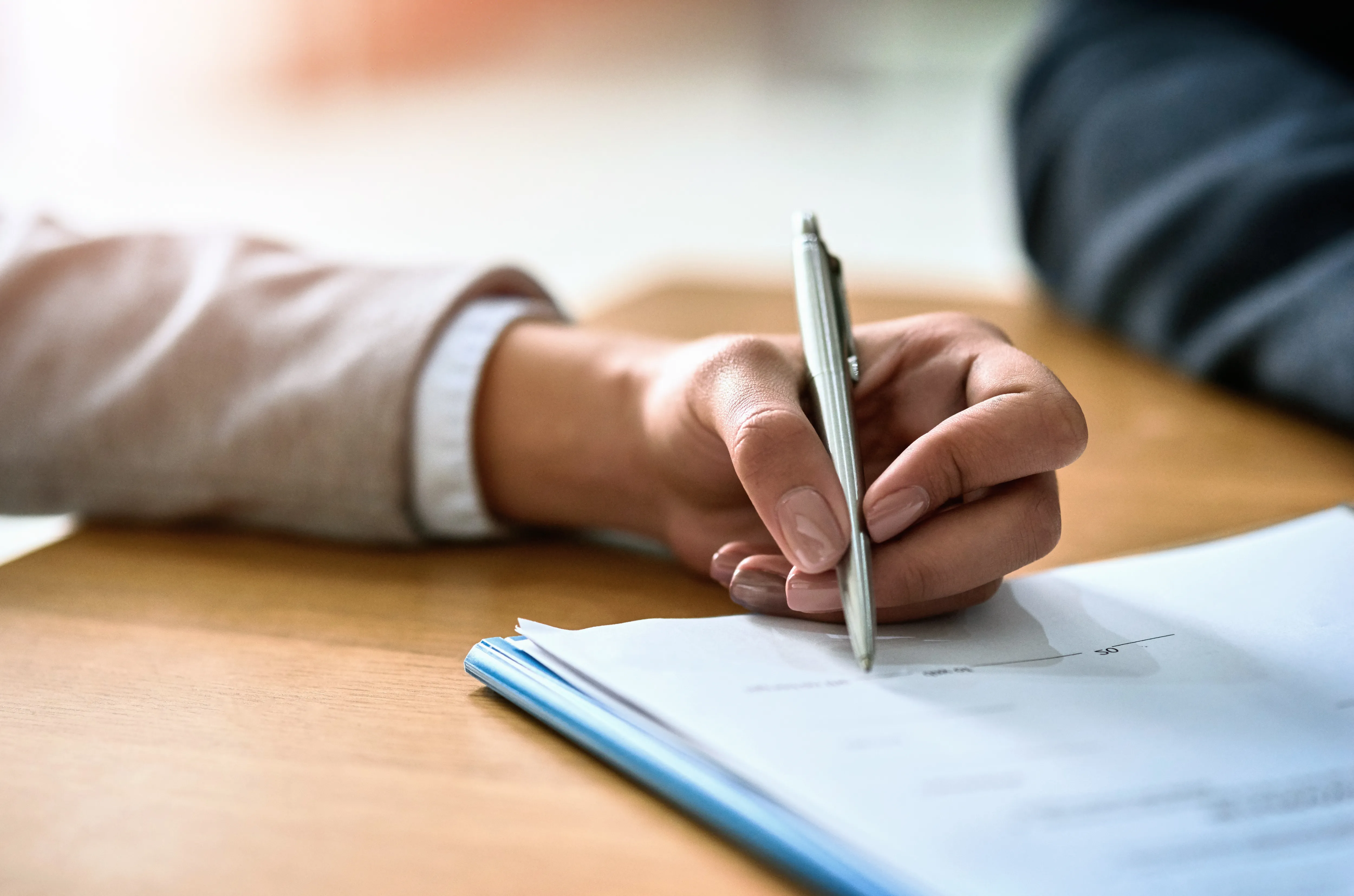 Woman, hands and signature on paper contract in office, compliance and attorney for legal documents. Female person, pen and application or merger for business deal, agreement and validation letter